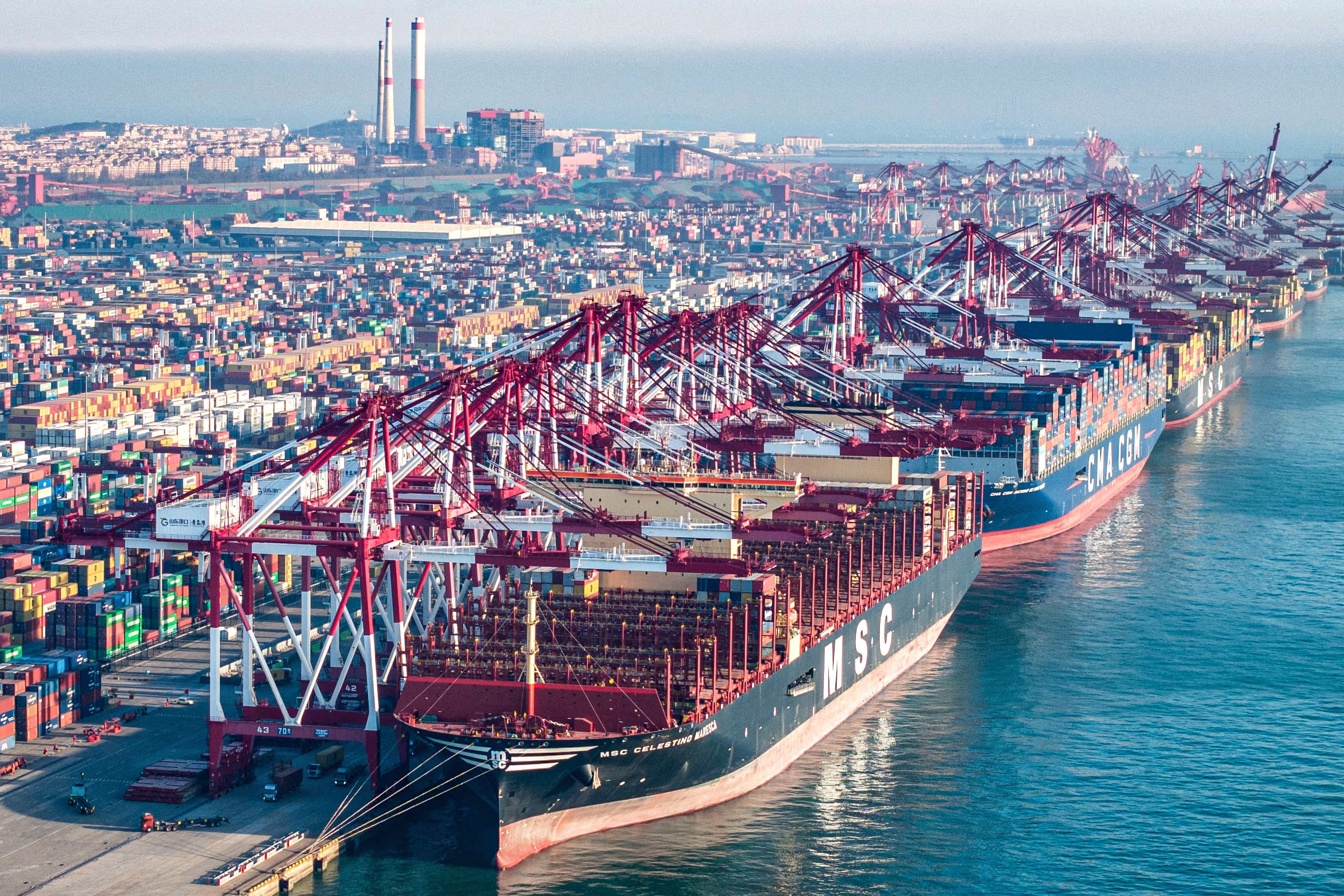 Cargo ships and containers at Qingdao port in eastern China's Shandong province on Dec. 4, 2024.