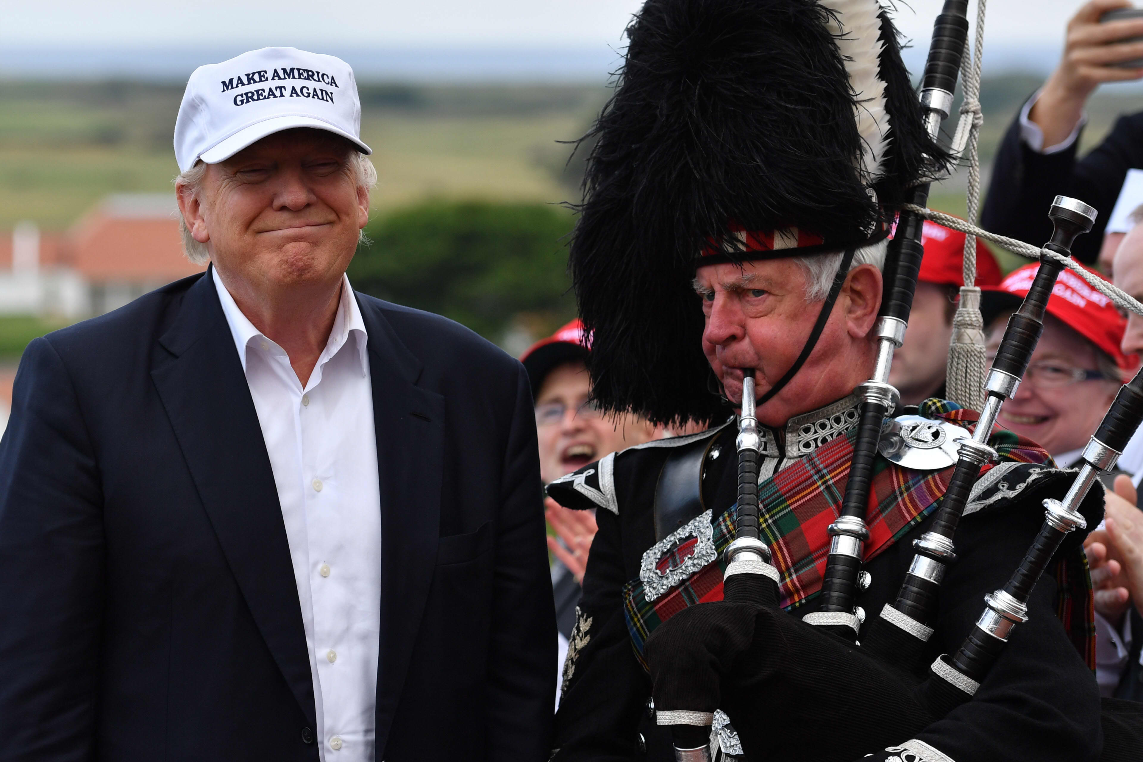A bagpipe player wears traditional dress next to Donald Trump as he arrived at his Trump Turnberry Resort on June 24, 2016 in Ayr, Scotland.